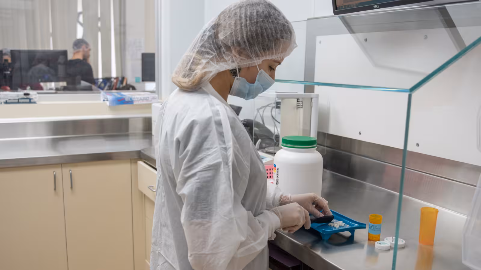 Compounding pharmacist preparing a custom medication